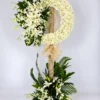 Halo white mum funeral wreath stand with white lilies, orchids and a flower base