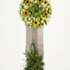 Sunflower one-layer funeral stand with orchids and carnations on a burlap-wrapped easel with palm and tuberose base