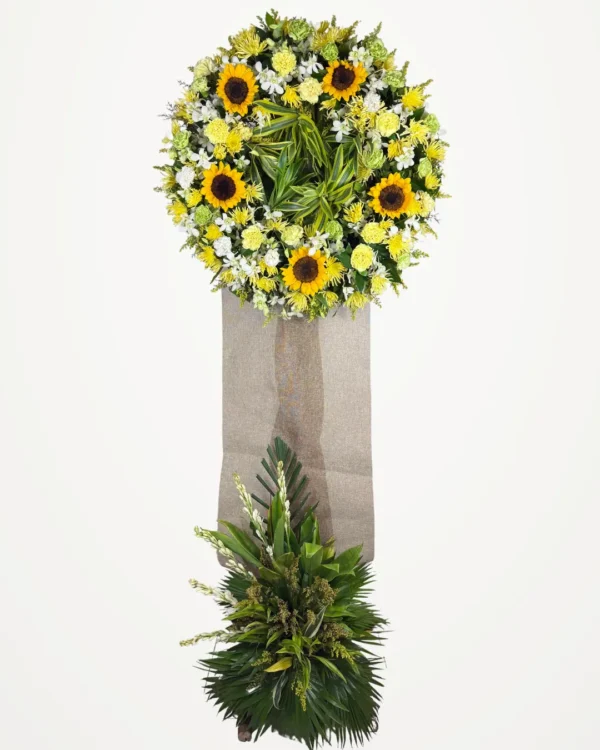 Sunflower one-layer funeral stand with orchids and carnations on a burlap-wrapped easel with palm and tuberose base